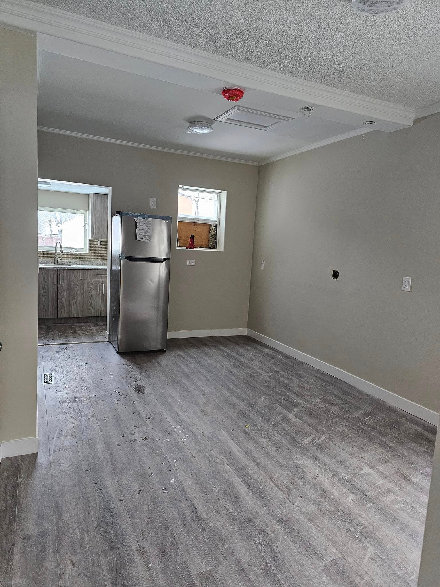 Renovated open-plan suite with new flooring and kitchen