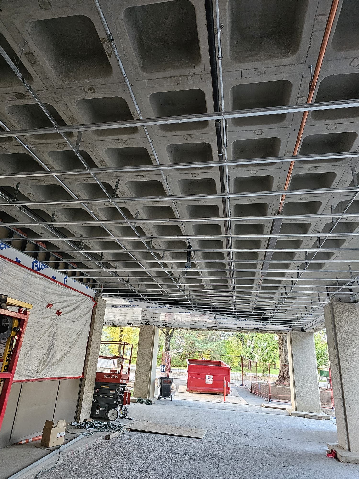 Steel framing grid installed under a concrete parkade ceiling