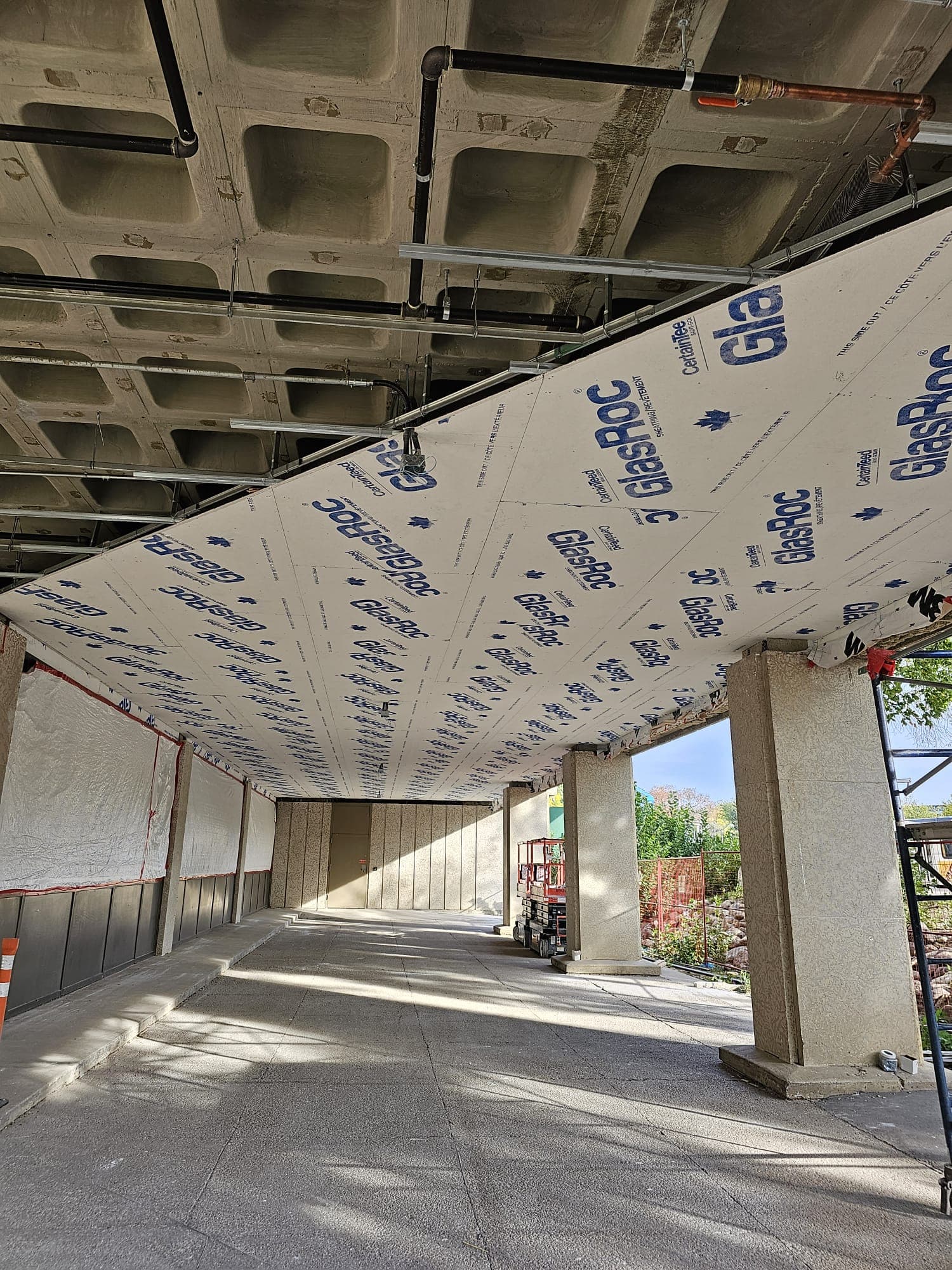 Exterior soffit sheathing installed over steel framing