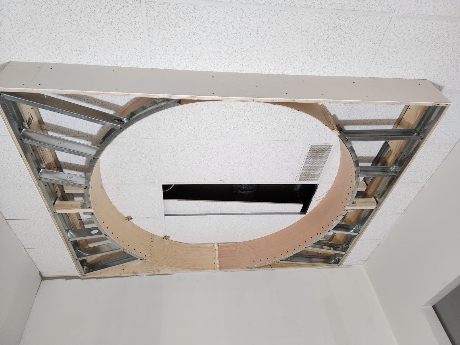 Steel stud framing around a round opening in a suspended ceiling