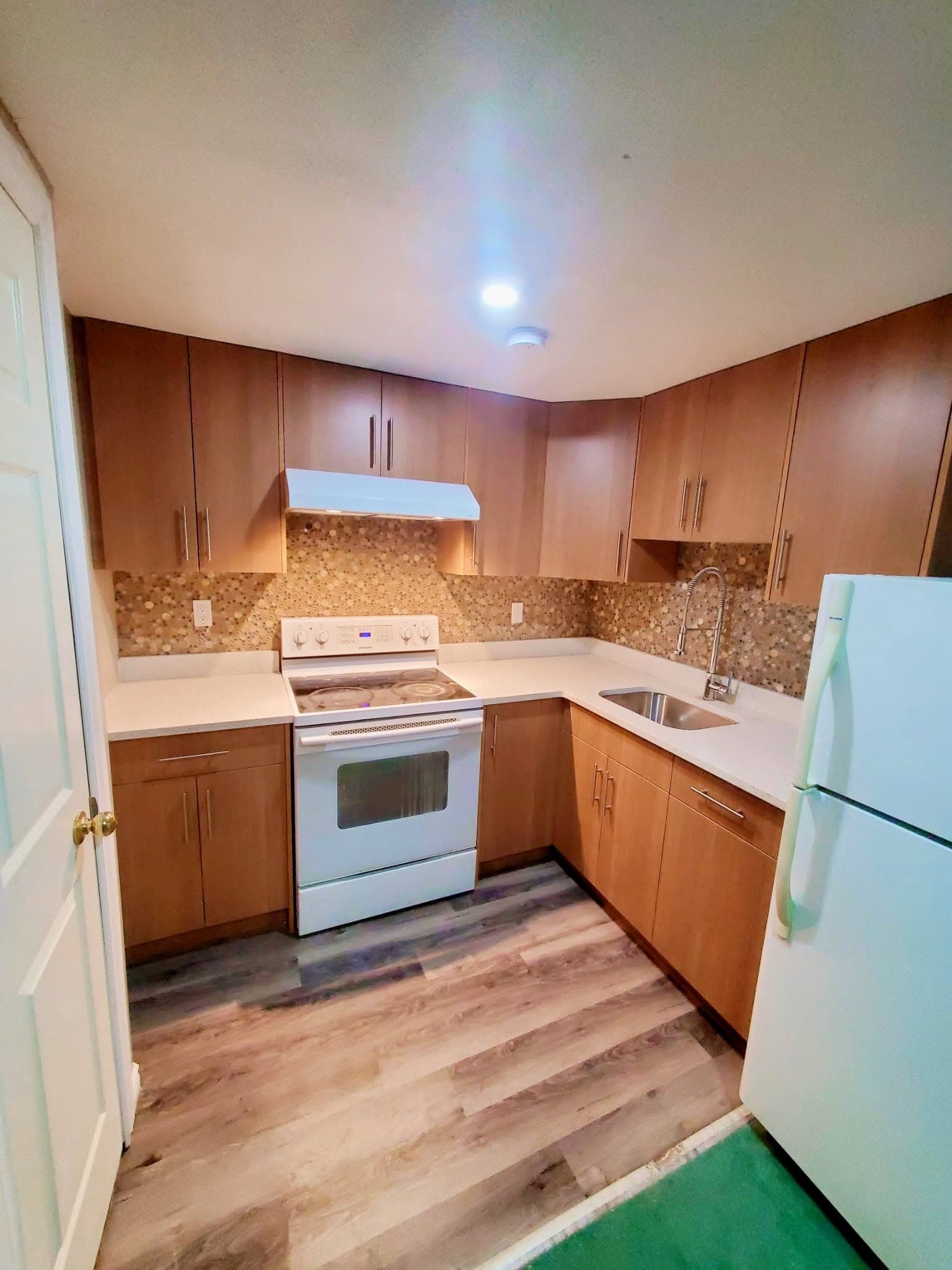 Renovated kitchen with wood cabinets