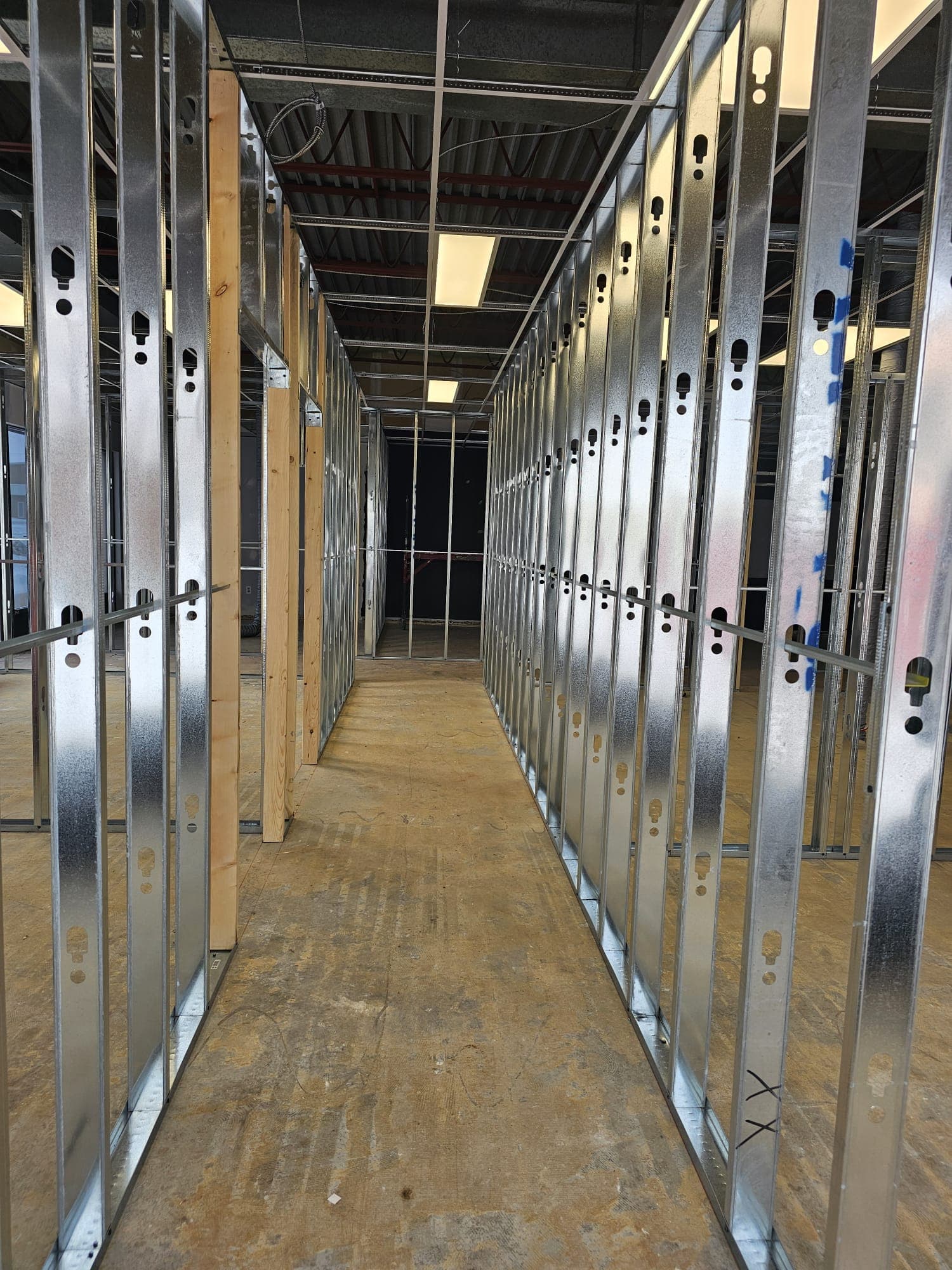 Long corridor of steel stud framing in a commercial build